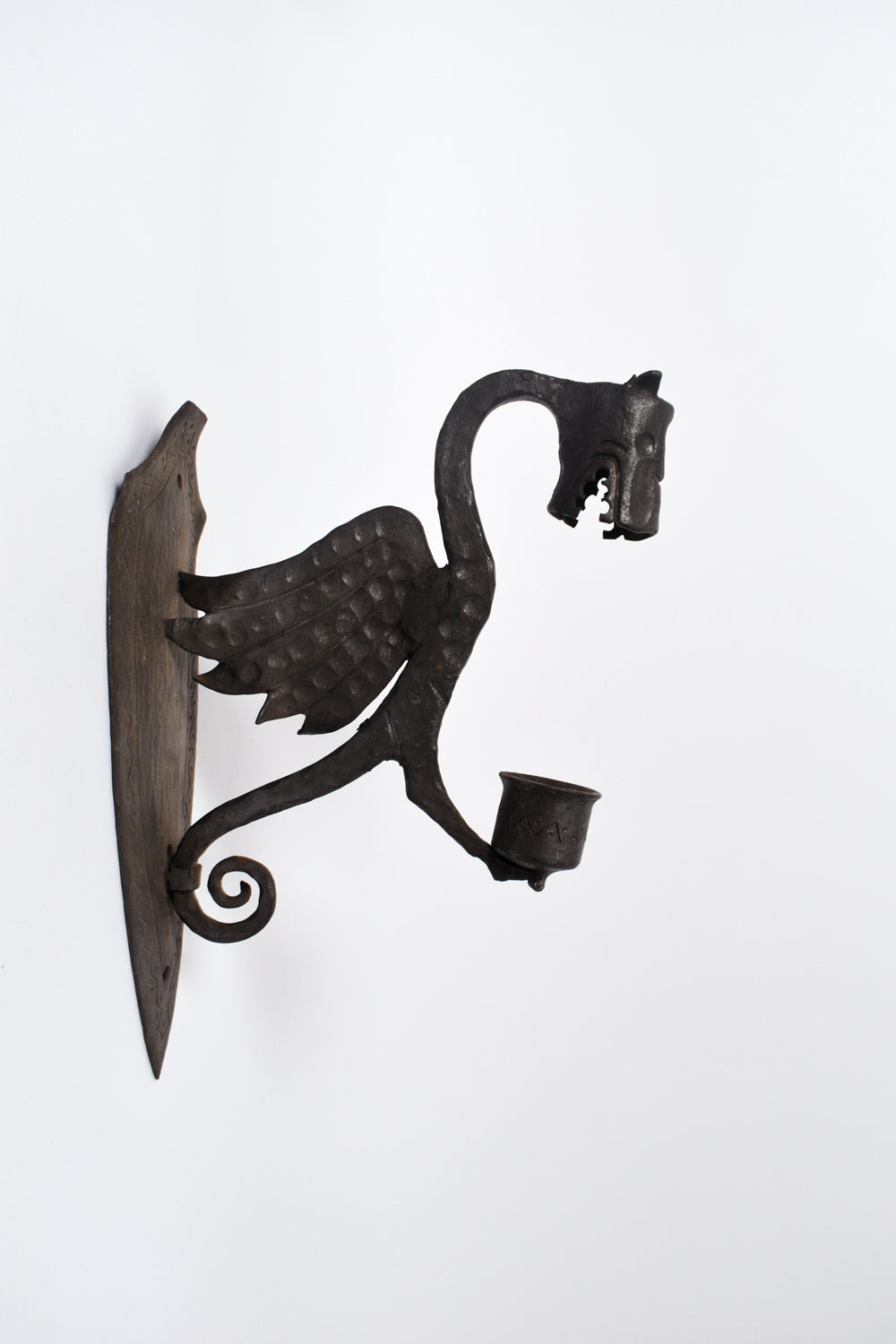 Pair of zoomorphic hammered iron mural candle holders representing dragons. France, 1960s.