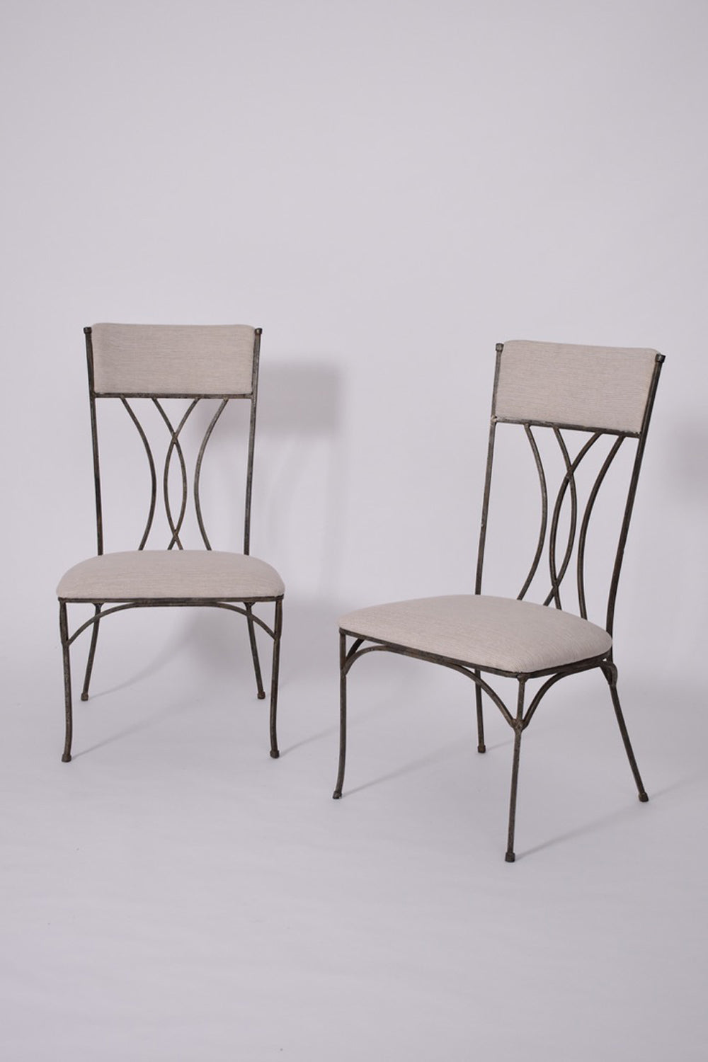 Pair of neoclassical iron chairs, 1960s.