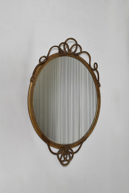 Important oval trimmings and pompoms mirror, XIXth c.