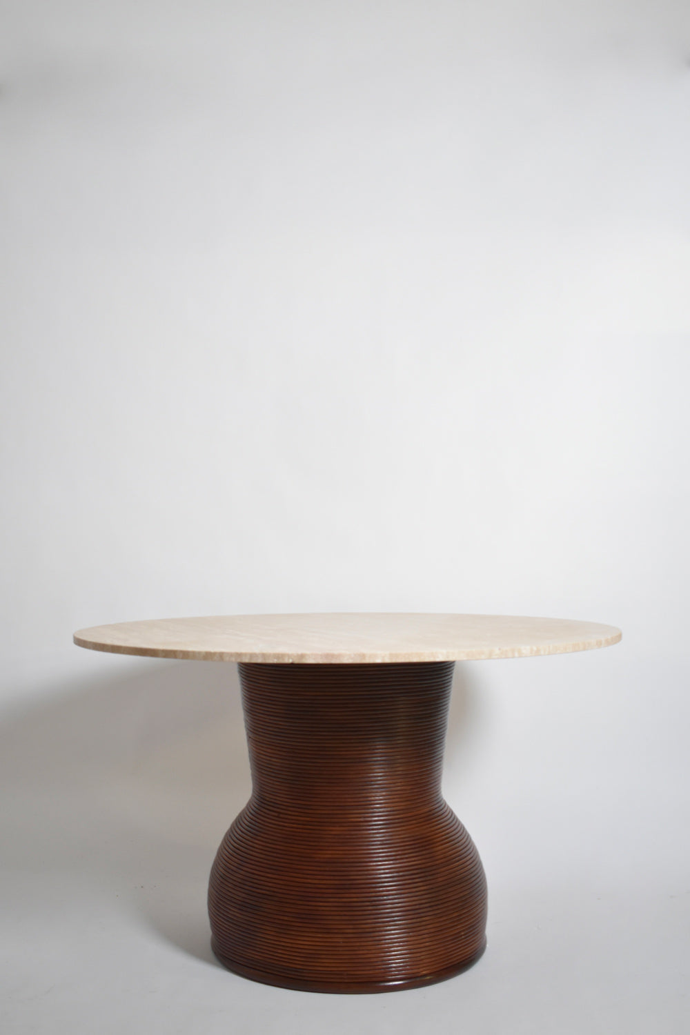 Rattan and travertine round dining table, 1970s.