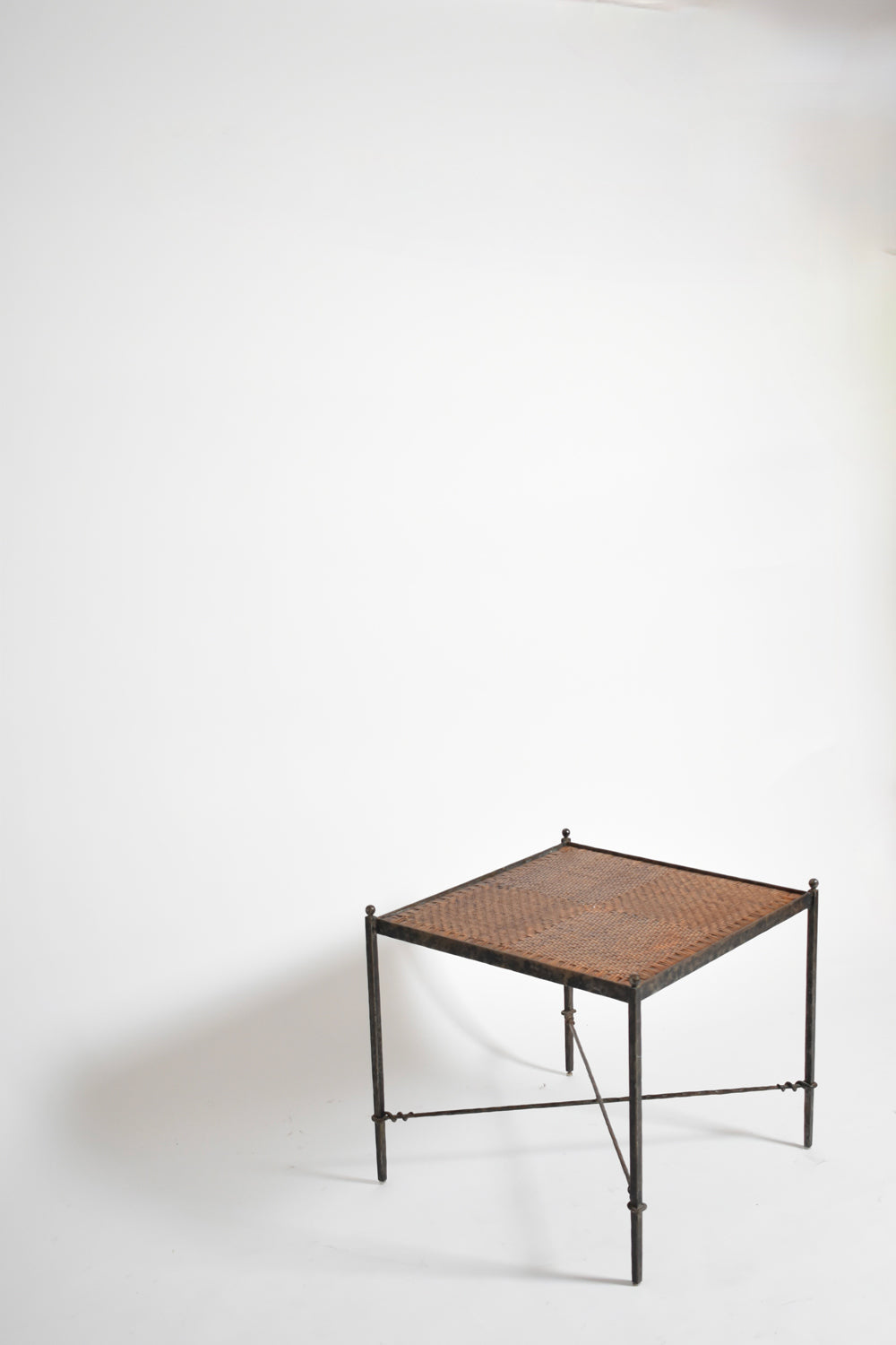 Pair of wrought iron and wicker side tables, 1970s.