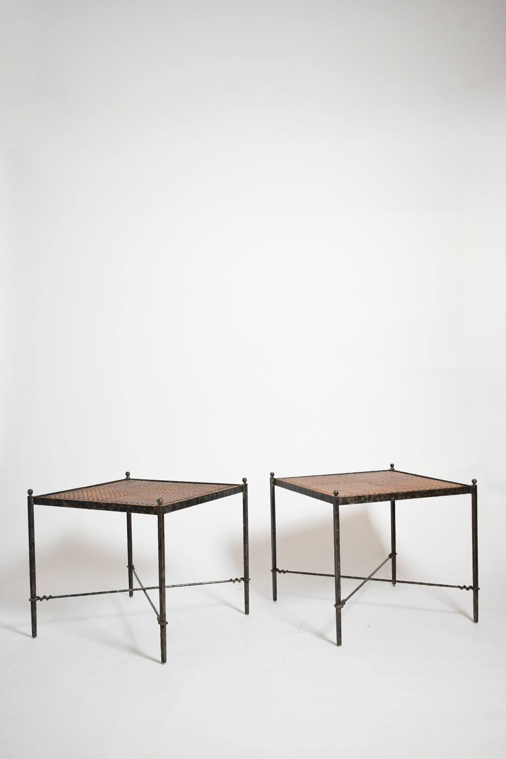 Pair of wrought iron and wicker side tables, 1970s.