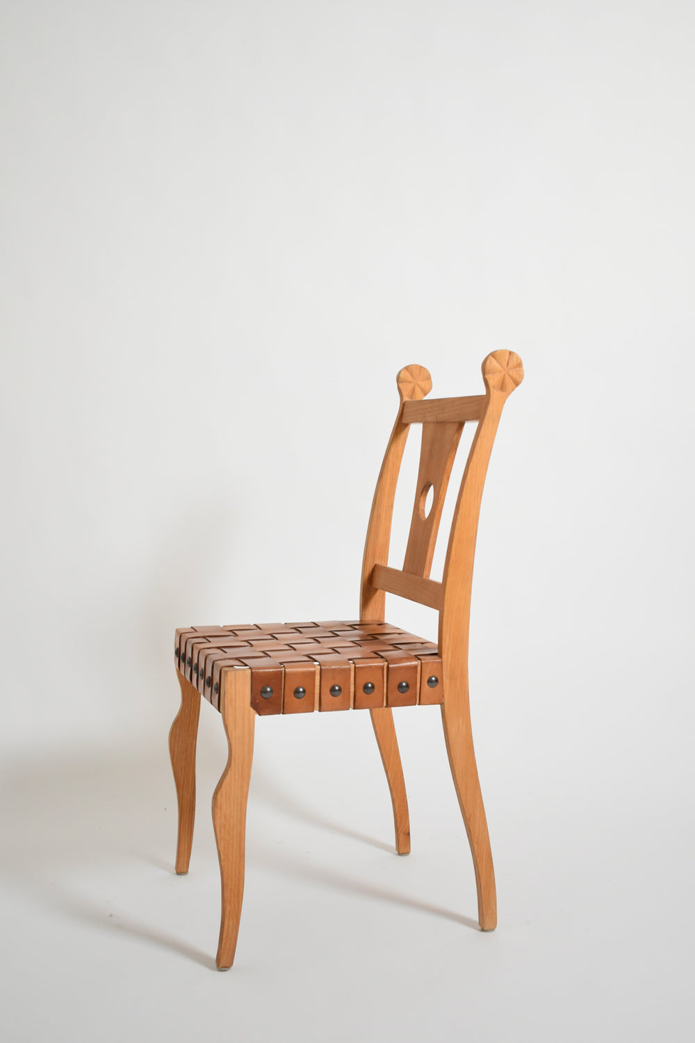 Pair of etruscan oak and leather chairs, 1970s.