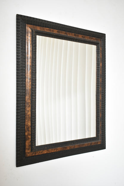Carved ebonised wood mirror and trompe l'oeil turshell, XIXth c.