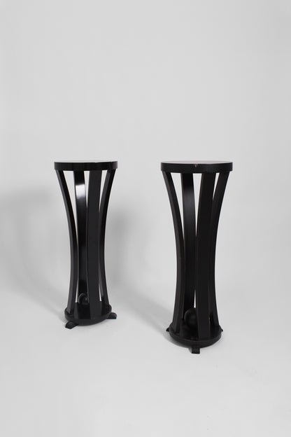 Pair of round black lacquered wooden pedestal tables, 1960s.