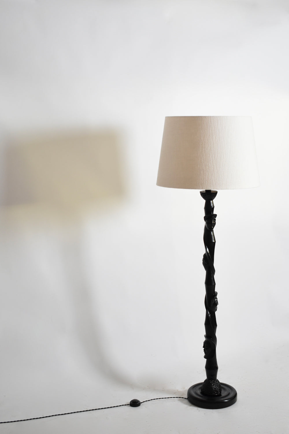 Africanist ebonised wood floor lamp, 1970s.
