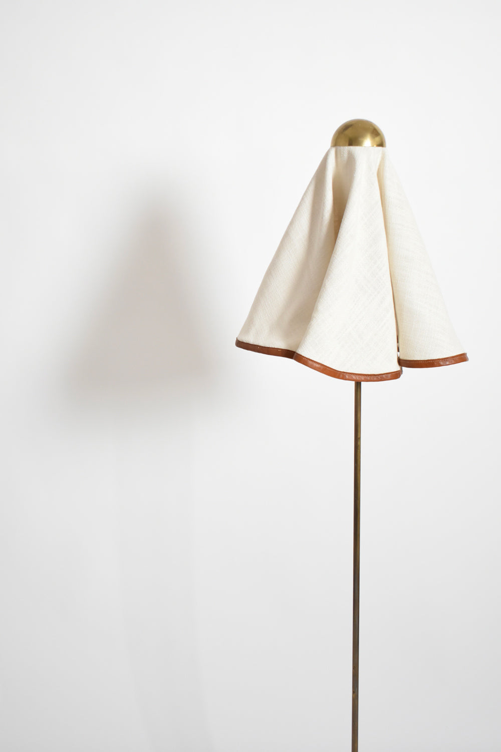 Brass, fabric and leather floor lamp, 1960s.