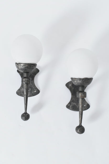 Pair of wrought iron and opaline wall sconces, 1950s.