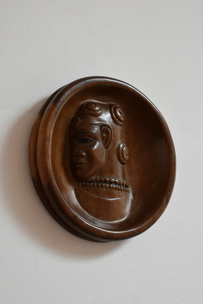 Africanist low relief round wooden wall sculpture, 1970s.
