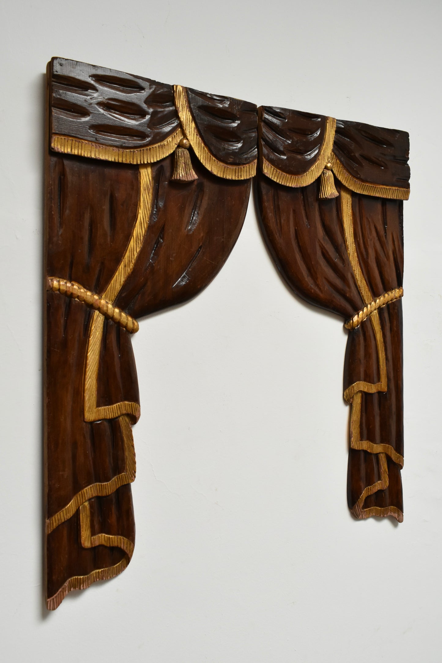 Pair of low relief wooden sculptered and gilded curtains, 1920s.