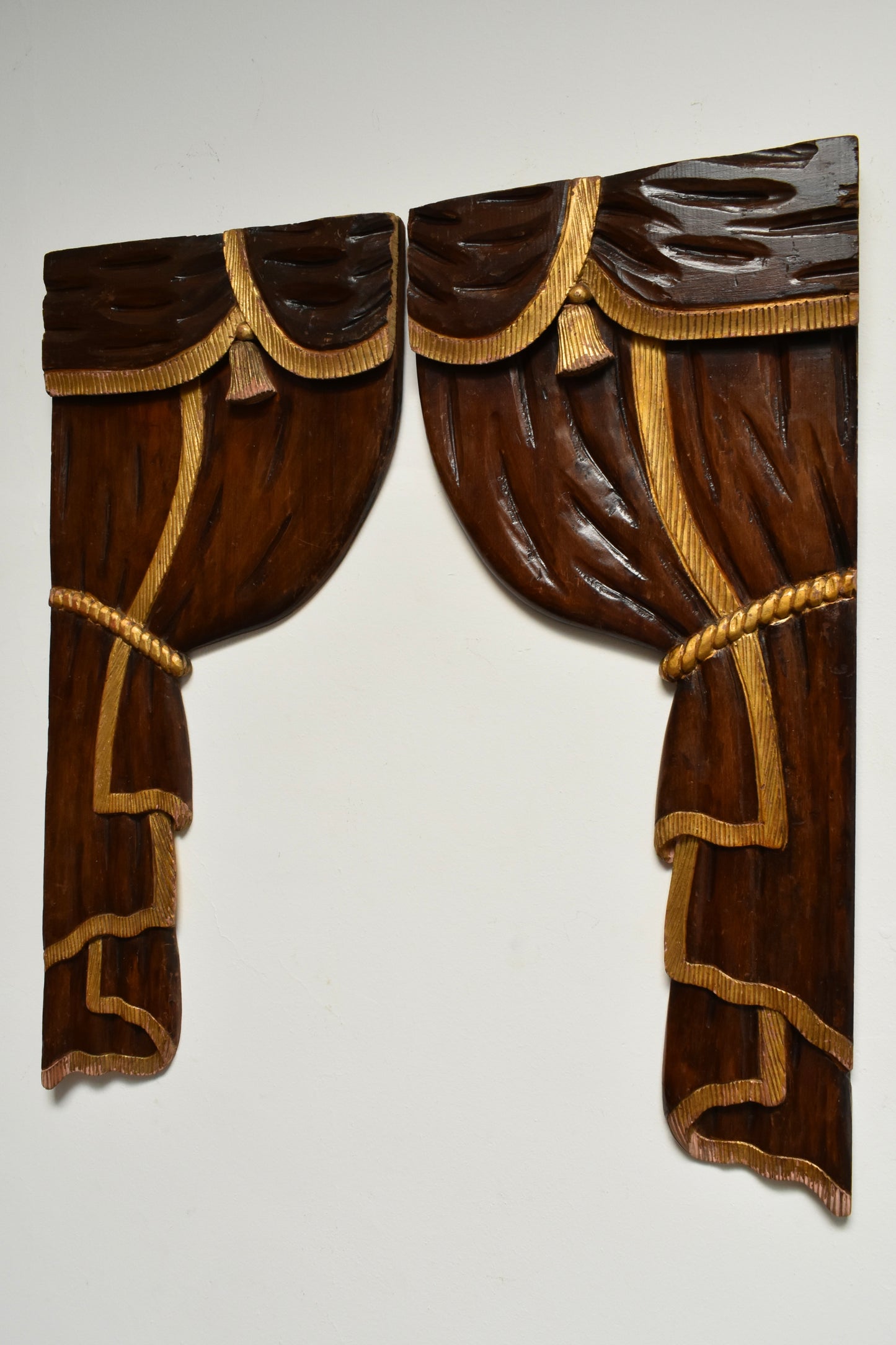 Pair of low relief wooden sculptered and gilded curtains, 1920s.