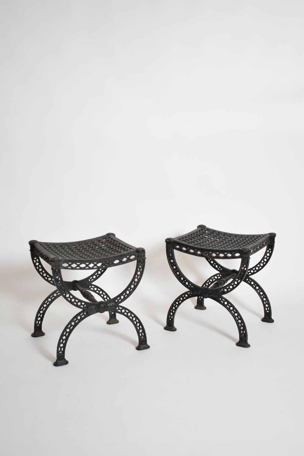 Pair of cast iron curule stools, 1970s.