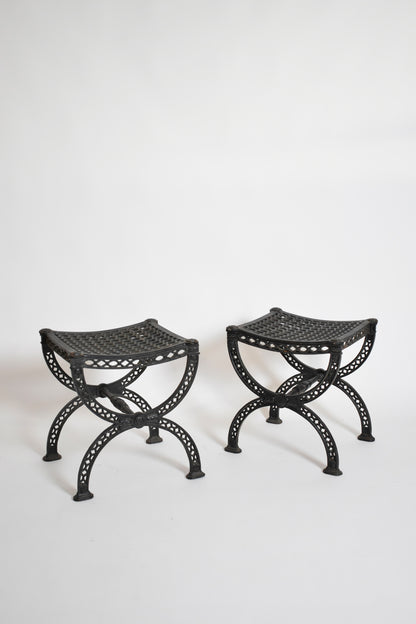 Pair of cast iron curule stools, 1970s.