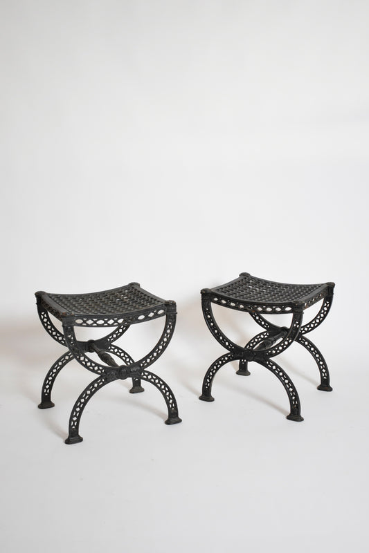 Pair of cast iron curule stools, 1970s.