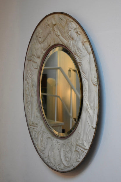 Important round embossed metal sheet mirror, 1910s.