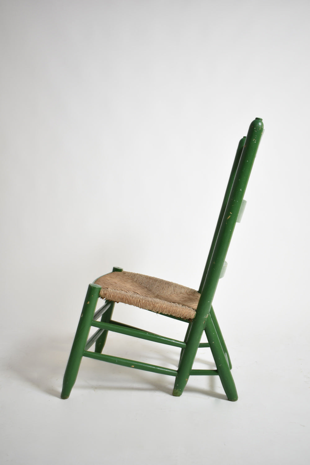 Green painted wood and straw fireside chair, 1960s.