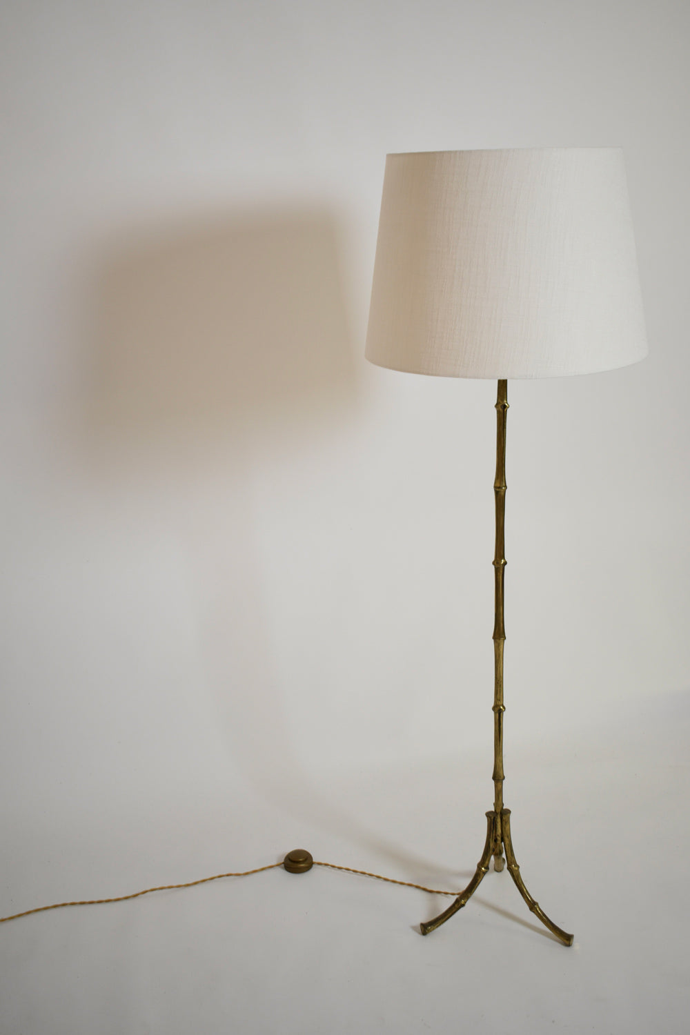 Jansen tripod faux bamboo solid brass floor lamp, 1960s.