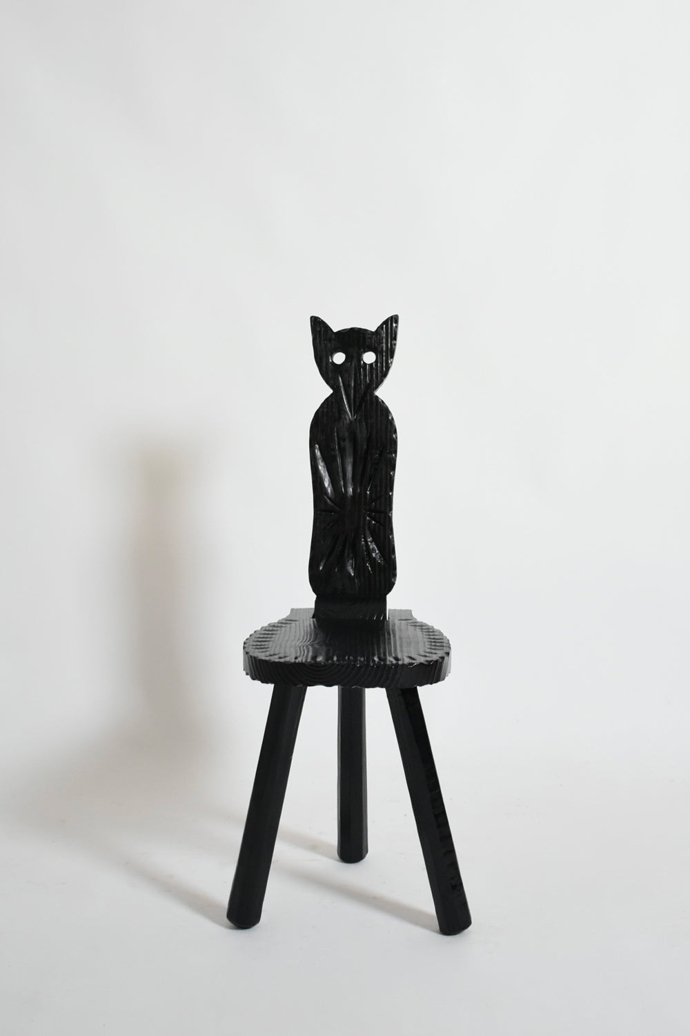 Pair of brutalist ebonised wood owl chairs, 1960s.