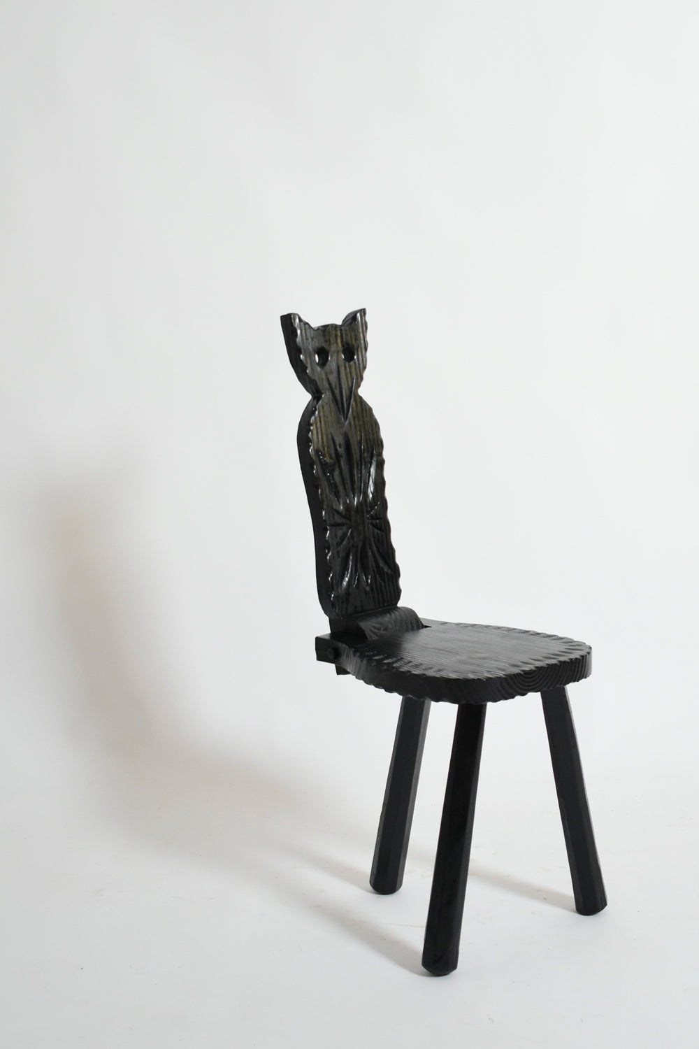 Pair of brutalist ebonised wood owl chairs, 1960s.