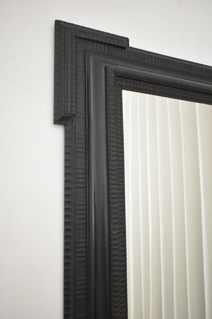 Carved ebonised wooden mirror, XIXth c.