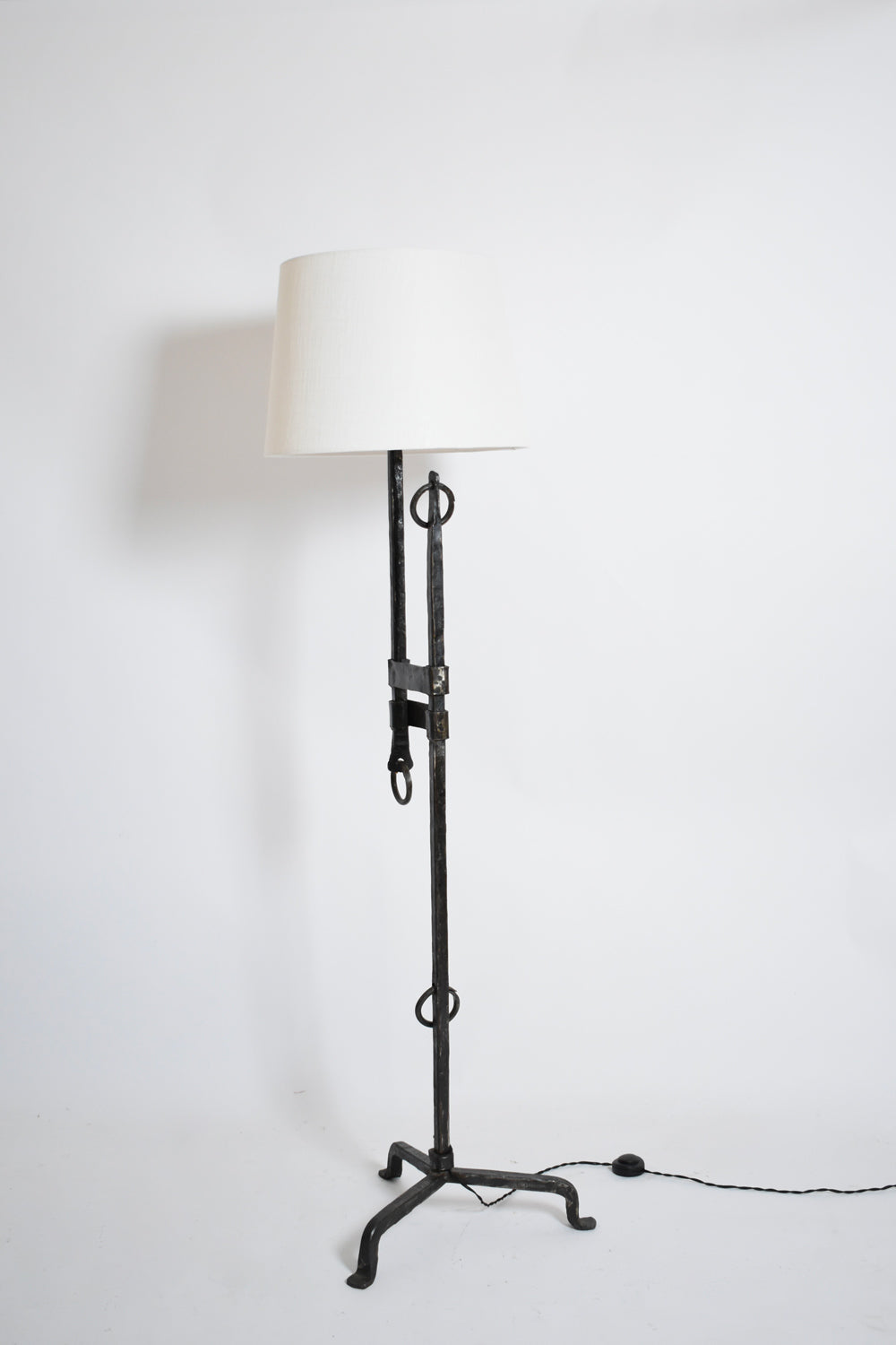 Tripod wrought iron adjustable floor lamp, 1950s.