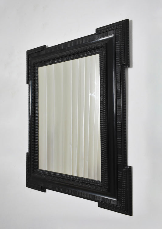 Carved ebonised wooden mirror, XIXth c.