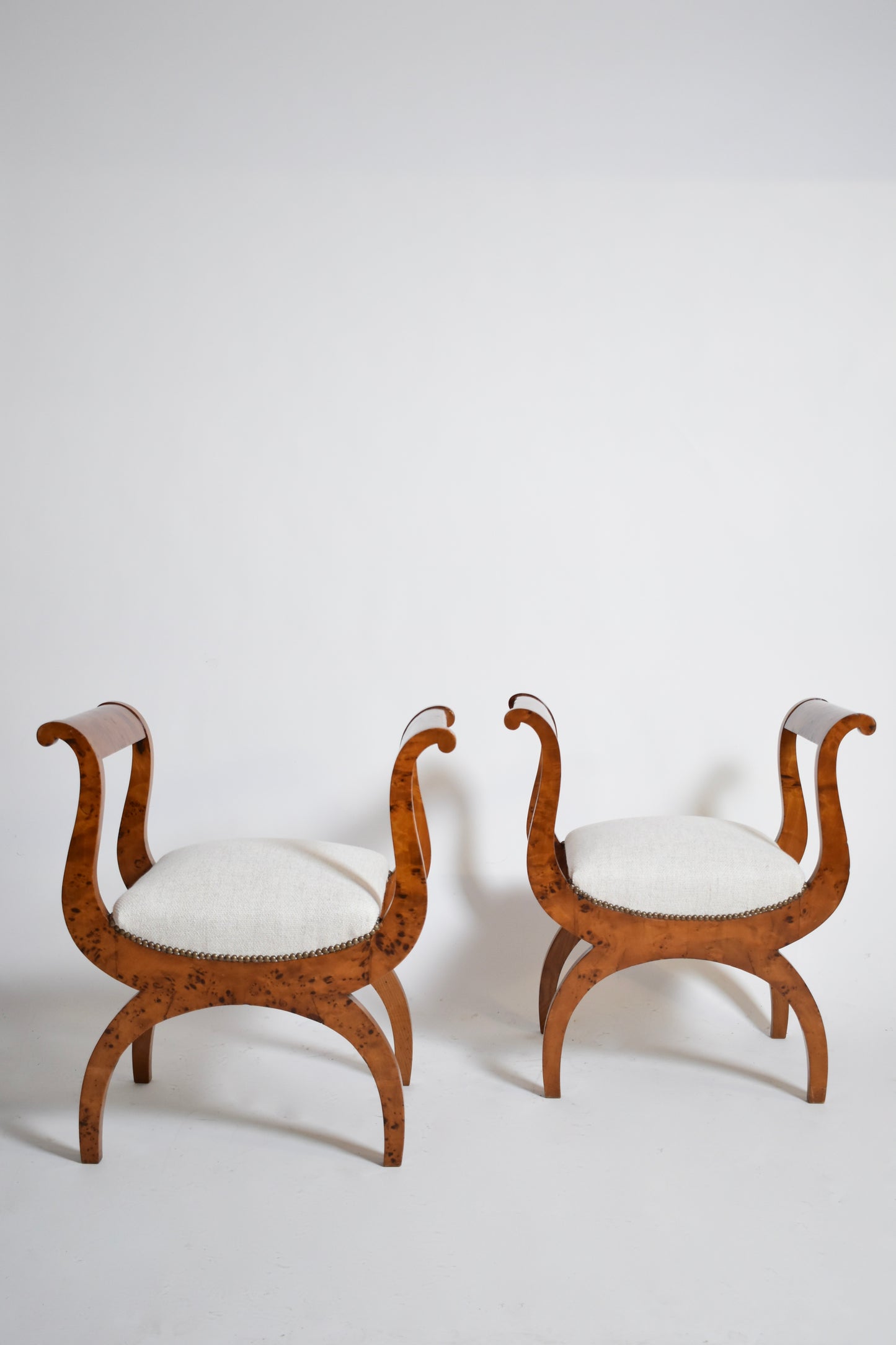 Pair of walnut curule stools, XIXth.