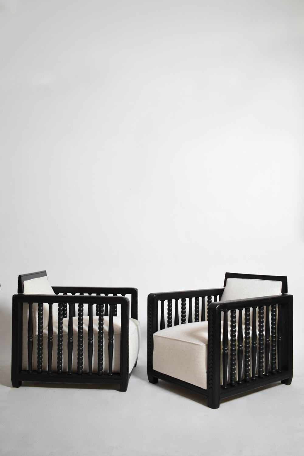 Pair of ebonised wood back top fireside armchairs, 1940s
