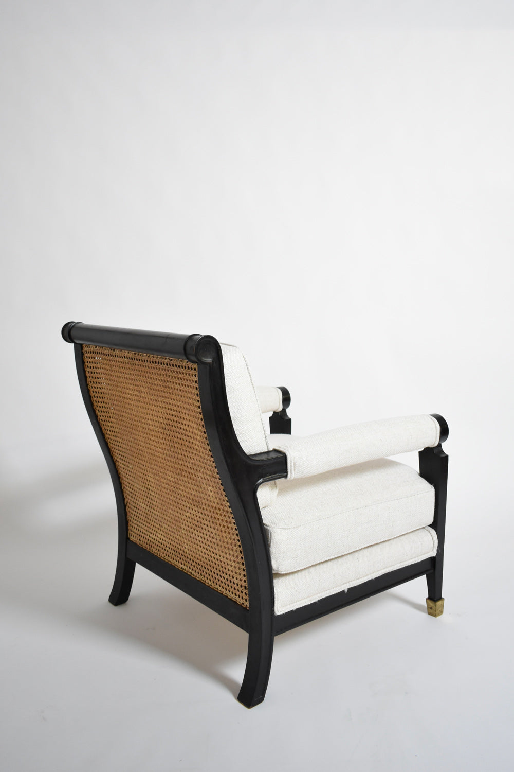 Pair of neoclassical ebonised wood and caning armchairs, 1960s.