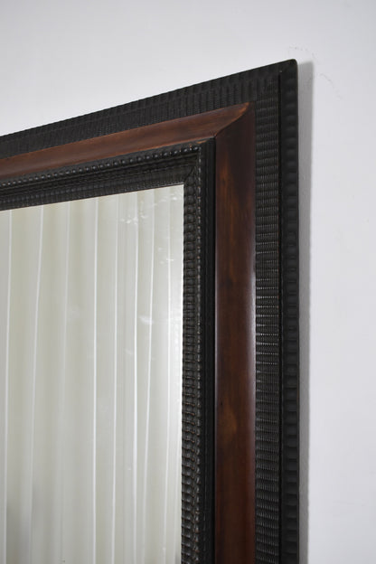 Carved ebonised wood mirror and trompe l'oeil turshell, XIXth c.