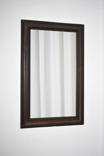 Carved ebonised wood mirror and trompe l'oeil turshell, XIXth c.