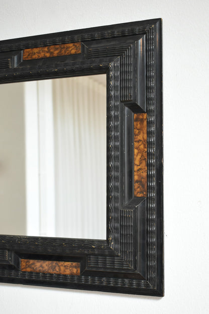 Pair of carved ebonised wood and trompe l'oeil turshell mirrors, XIXth c.