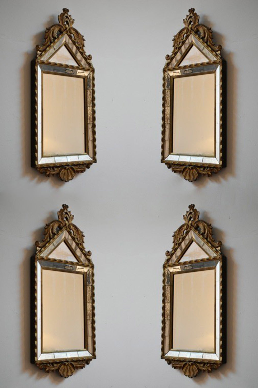 Set of four Pierre Dariel acanthus pediment mirrors, 1940s.