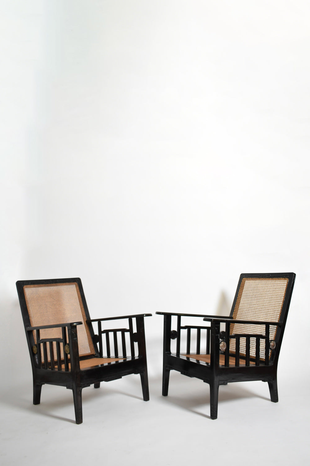Pair of colonial ebonised wood & caning armchairs, 1920s.