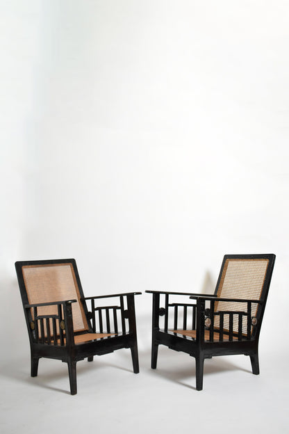 Pair of colonial ebonised wood & caning armchairs, 1920s.