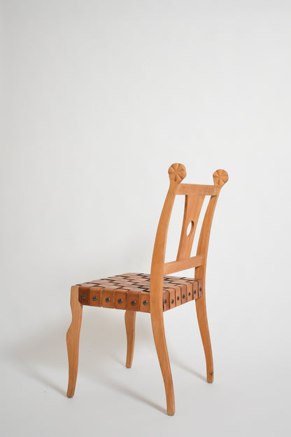 Pair of etruscan oak and leather chairs, 1970s.