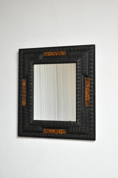 Pair of carved ebonised wood and trompe l'oeil turshell mirrors, XIXth c.