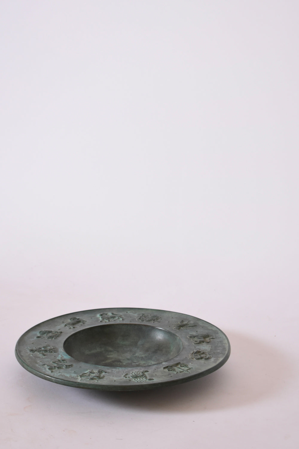Circular neoclassical bronze plate, 1940s.