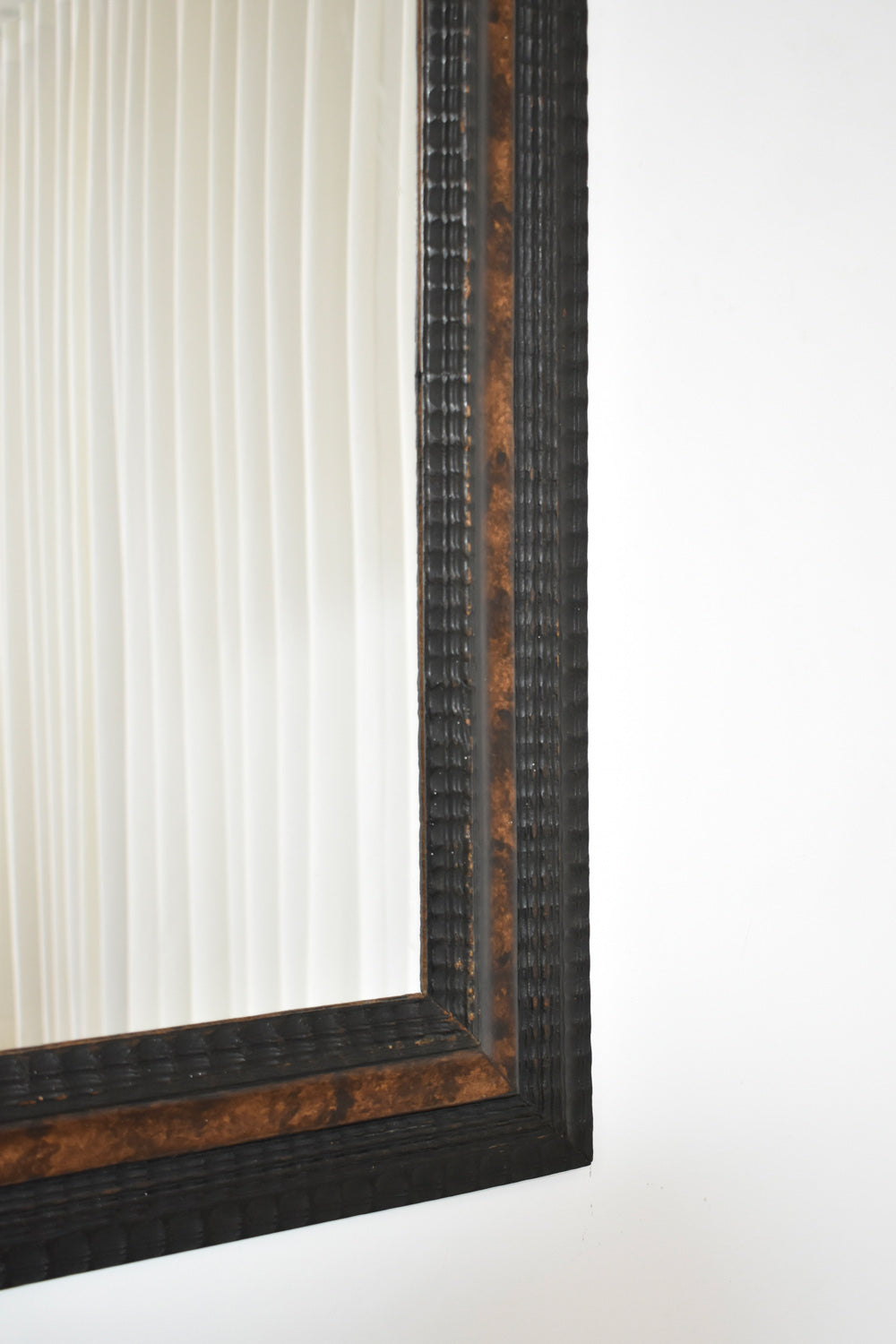 Carved ebonised wood mirror and trompe l'oeil turshell, XIXth c.