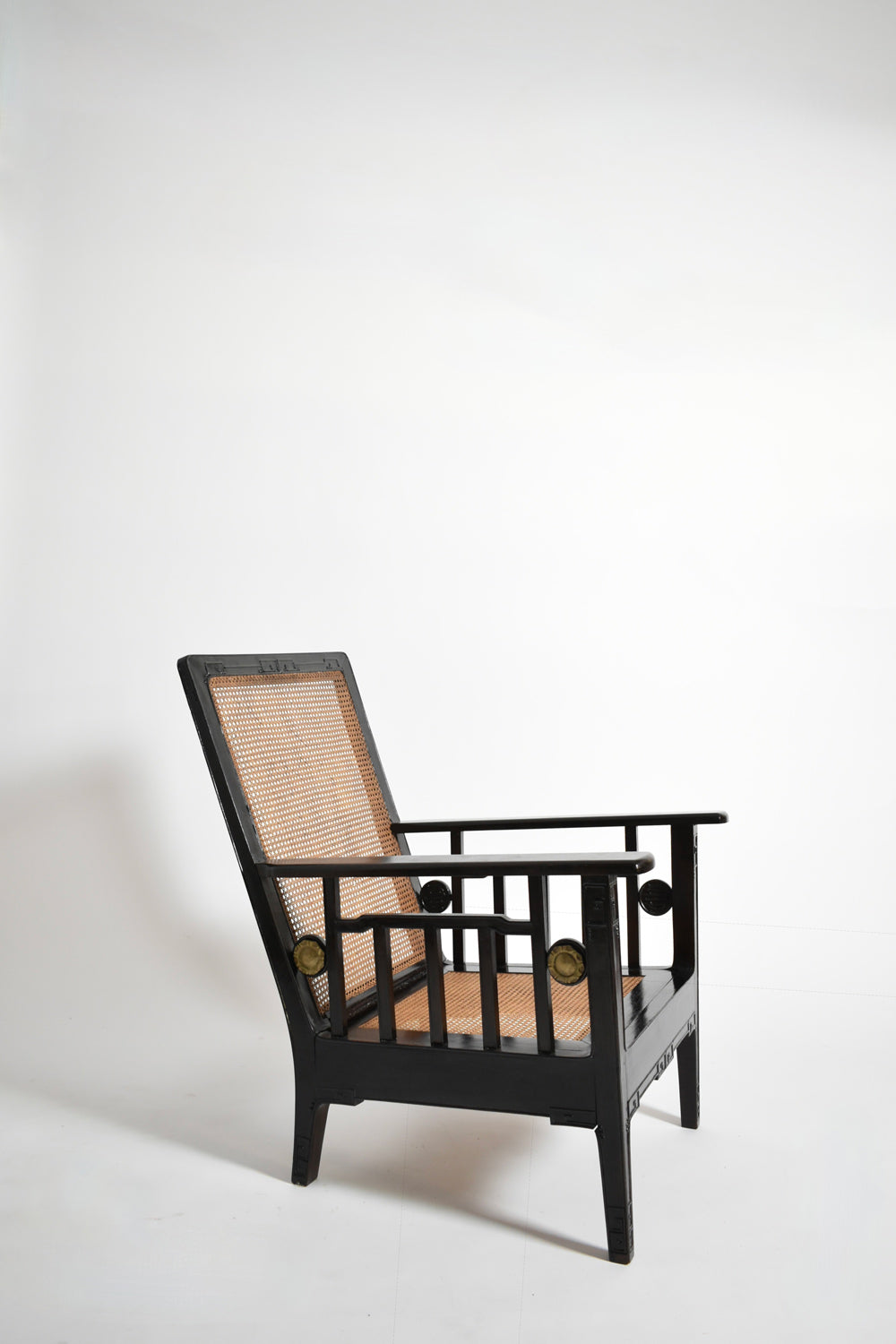Pair of colonial ebonised wood & caning armchairs, 1920s.