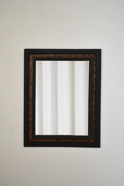 Carved ebonised wood mirror and trompe l'oeil turshell, XIXth c.