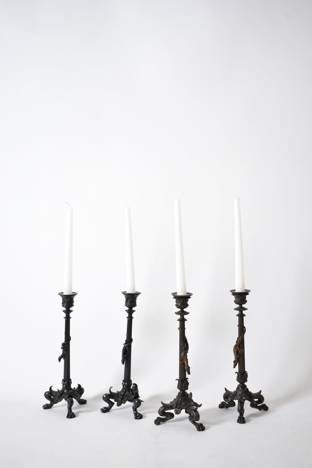 Set of four tripod zoomorphic bronze candleholders, XIXth c.