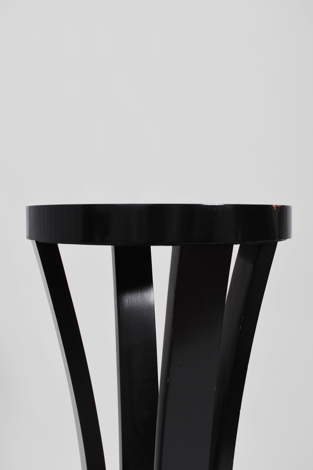 Pair of round black lacquered wooden pedestal tables, 1960s.