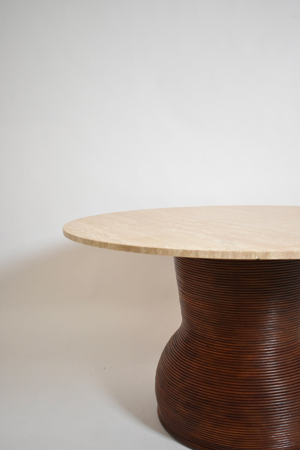 Rattan and travertine round dining table, 1970s.