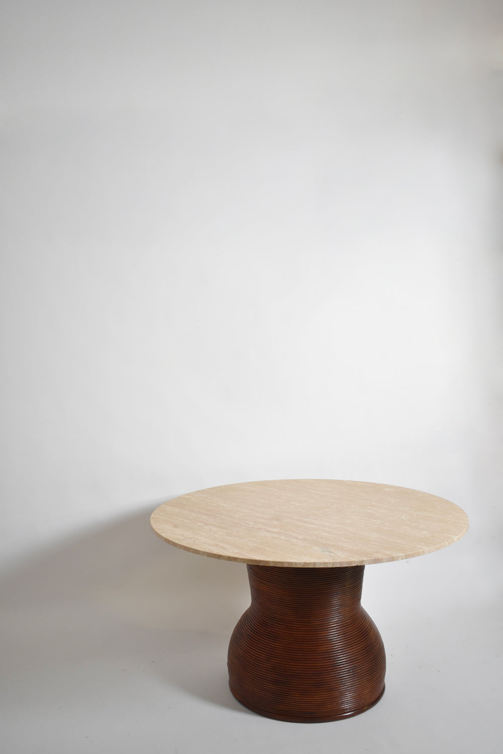 Rattan and travertine round dining table, 1970s.