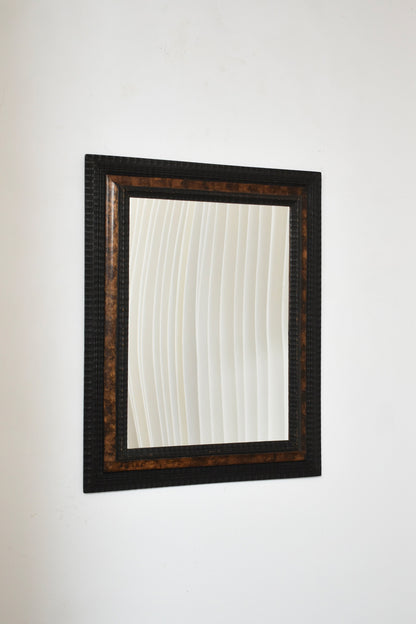 Carved ebonised wood mirror and trompe l'oeil turshell, XIXth c.