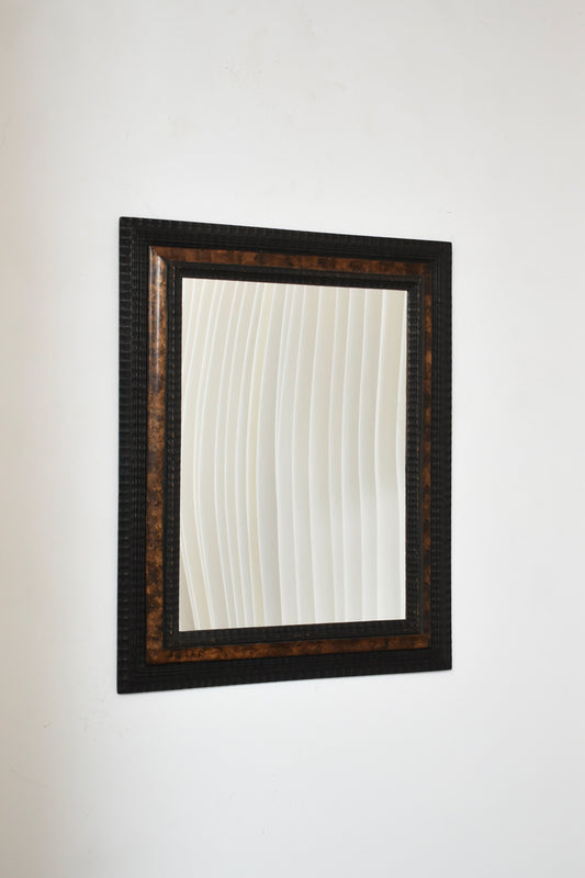 Carved ebonised wood mirror and trompe l'oeil turshell, XIXth c.