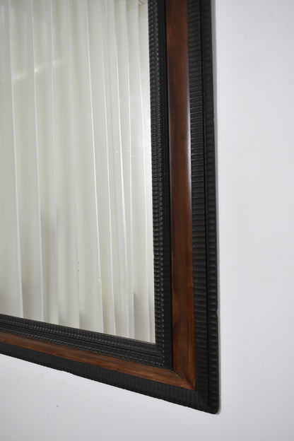 Carved ebonised wood mirror and trompe l'oeil turshell, XIXth c.