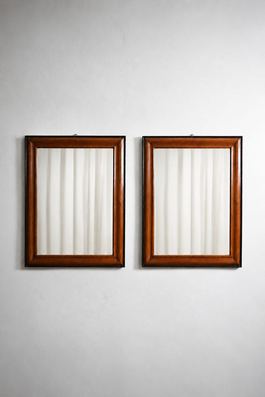 Pair of bicolor wood and ebonised wood mirrors, XIXth c.