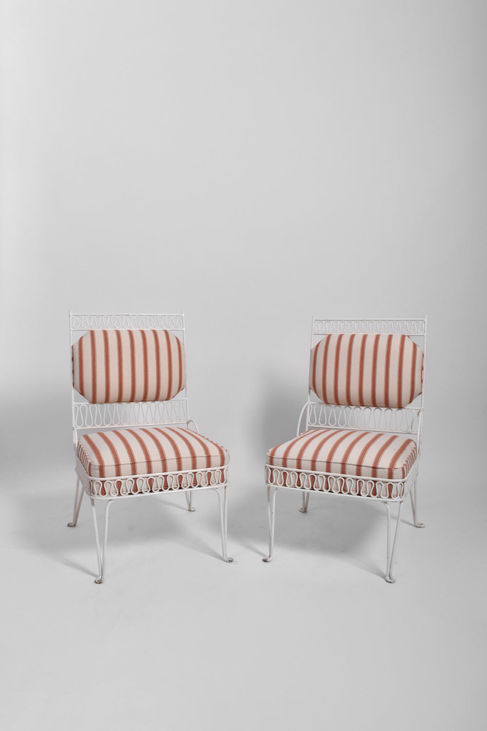 Pair of white tubular fireside chairs, 1950s.